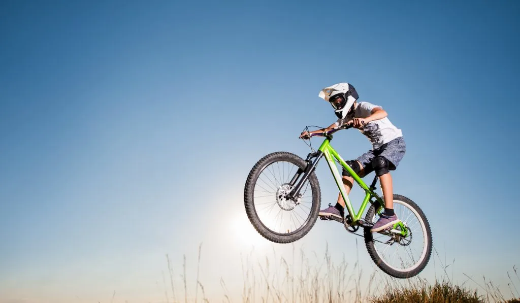 cyclist jumping off with bike