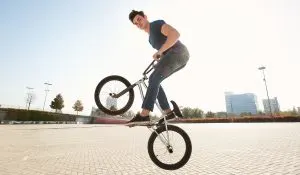 bmx rider in a jump on the street in the background of the city