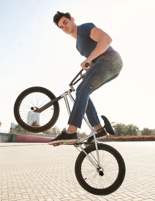 bmx rider in a jump on the street in the background of the city