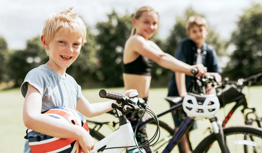 Kids riding bikes, enjoying summer holiday
