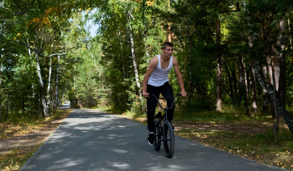 Man Riding BMX in Forest
