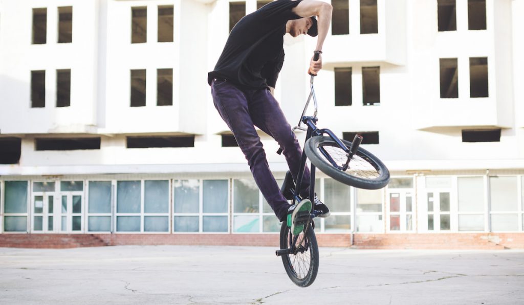 Young BMX bicycle rider doing tricks
