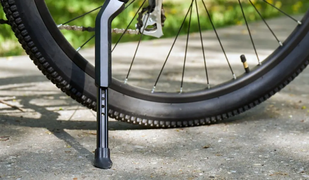 closeup photo of the kickstand of a bike